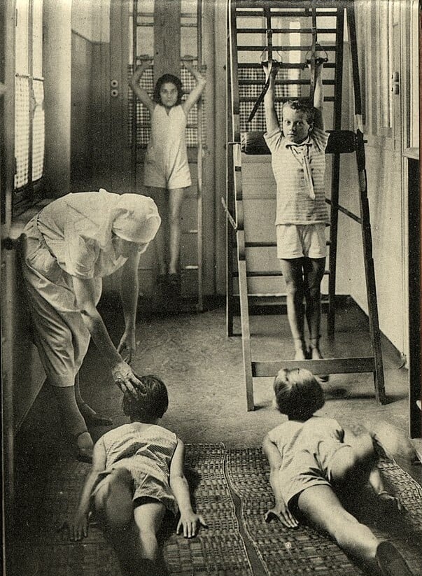 Tuberculosis preventorium children being instructed in exercise by a nurse