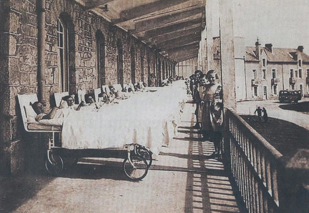 Children in movable beds on a sun porch at tuberculosis preventorium