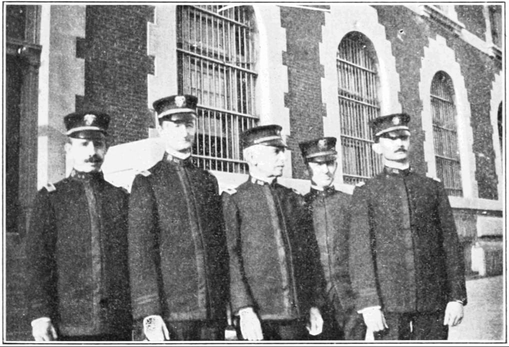Five men in early 1900s medical inspector uniforms